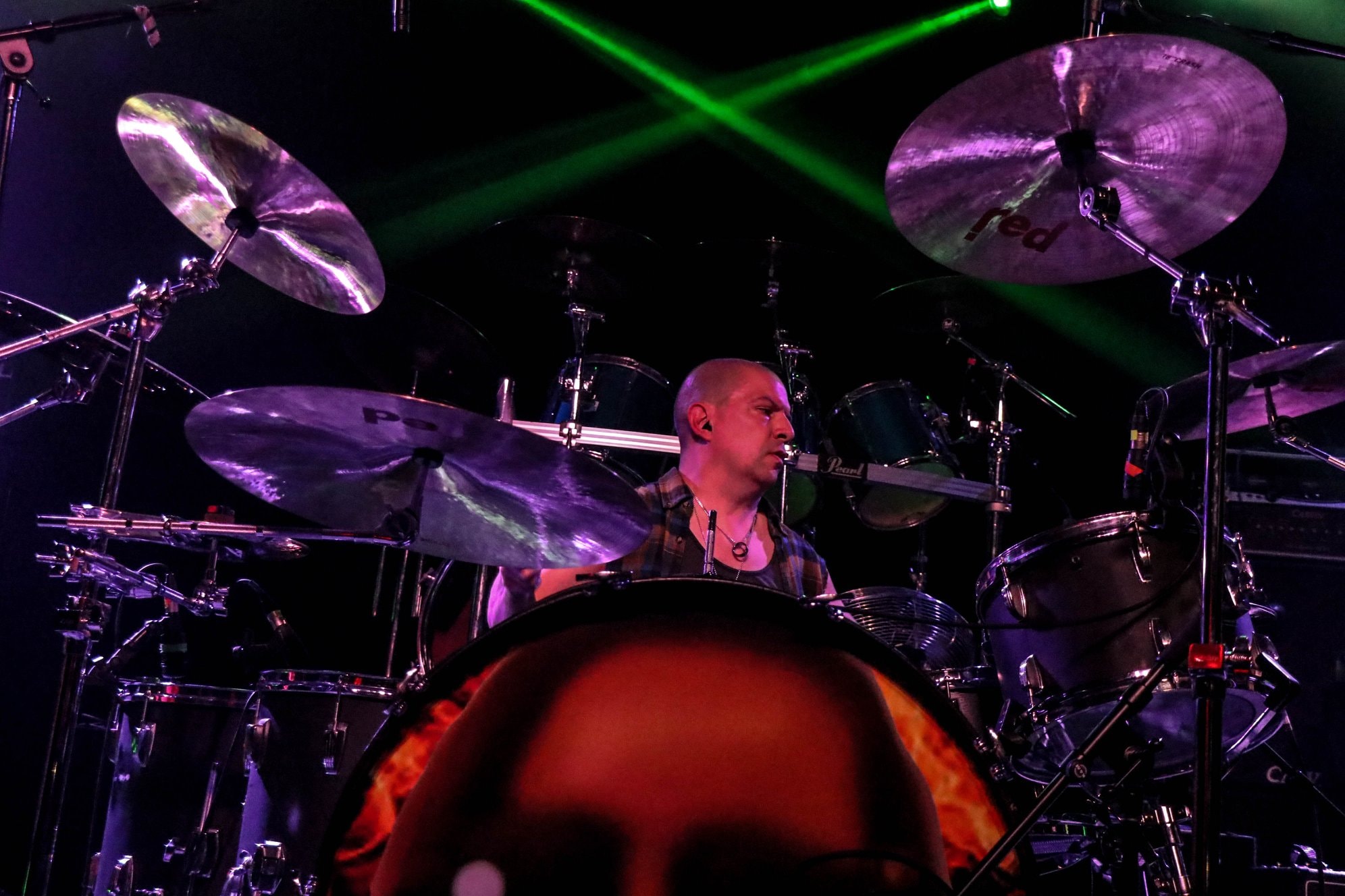 Daniel Jesse on stage under purple and green laser lights